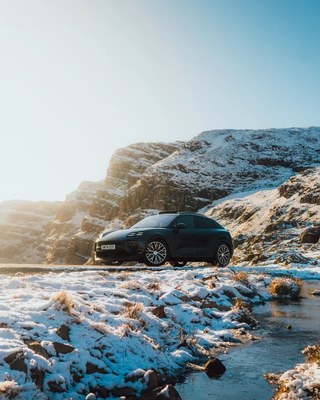 Porsche beside a snowy mountain stream