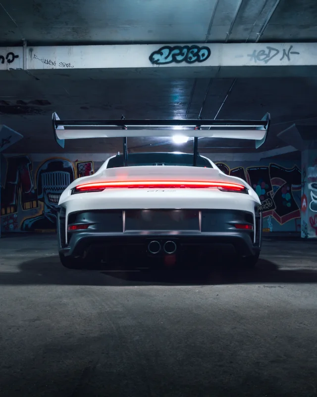 Rear view of a white Porsche in a car park